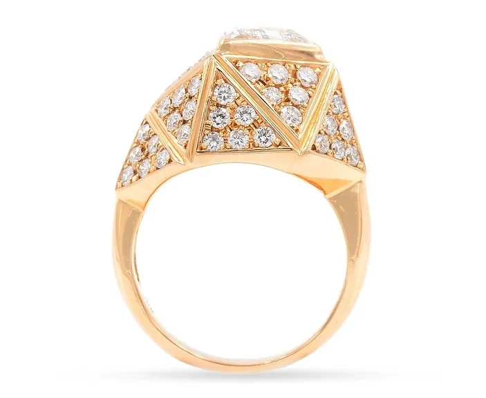 A vintage 18-karat yellow-gold engagement ring features a geometric design with triangle-shaped faces that are pavé set with diamonds. Offered by Platt Boutique Jewelry. 
